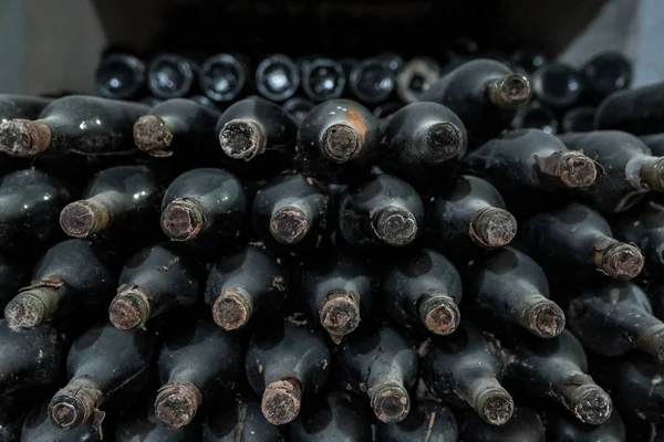 This wine bottles covered in dust and mold are over 20 years old