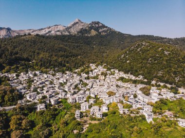 Thasos island small town of Panagia in the middle of the island, with houses painted in white and stone roofs, traditional greek way clipart