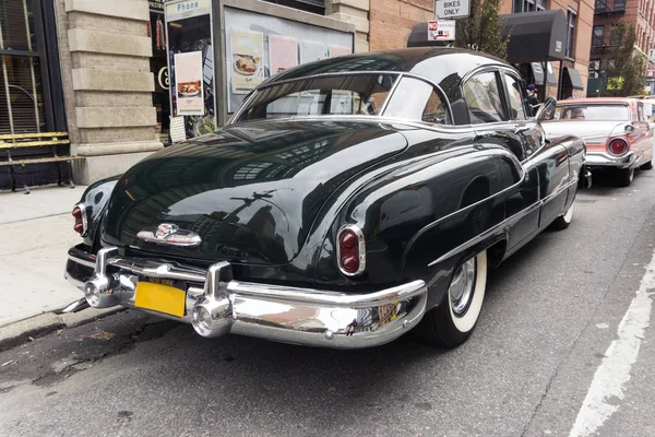 A view of a classic vintage car in the street in NYC