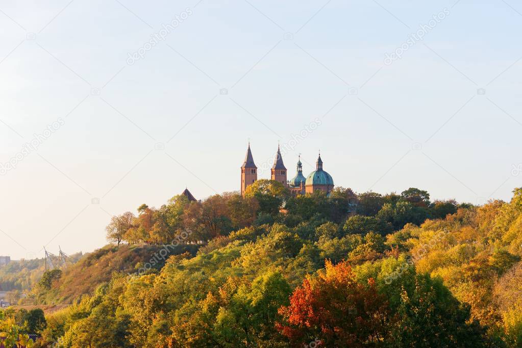 Cathedral towers amidst autumnal trees, Tumskie Hill in Plock, Poland
