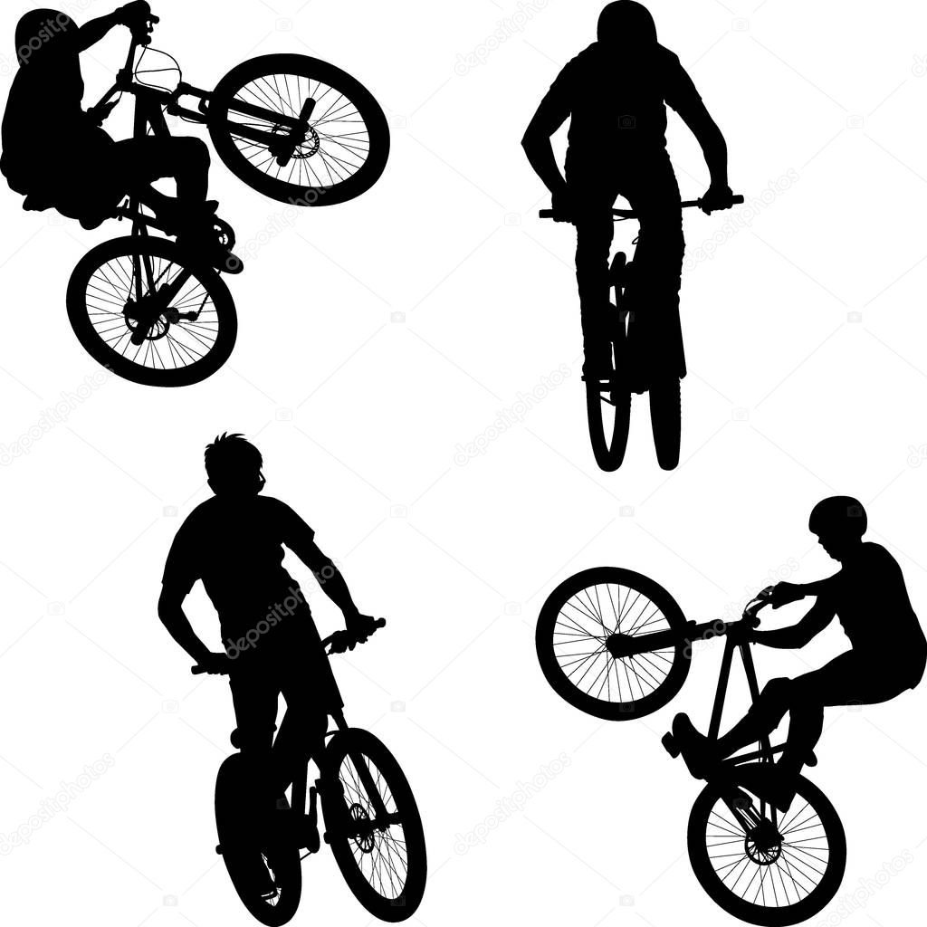 silhouette of male doing bike trick