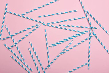 Pembe arka planda çizgili koktail pipetler. Doğum günü partisi kutlama soyut moda bebek duş kavramı. Minimalist pastel tarzı.