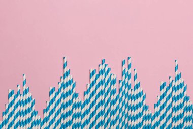 Pembe arka planda çizgili koktail pipetler. Doğum günü partisi kutlama soyut moda bebek duş kavramı. Minimalist pastel tarzı.