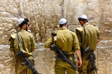Jerusalem Israel May 21, 2018 View of Israeli soldiers praying front the Western wall in the old city of Jerusalem in the evening clipart