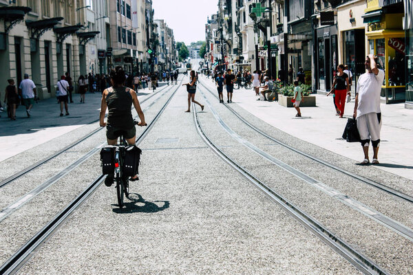 Reims France July 23, 2018 View of unknown people on bicycle in the street of Reims in the afternoon
