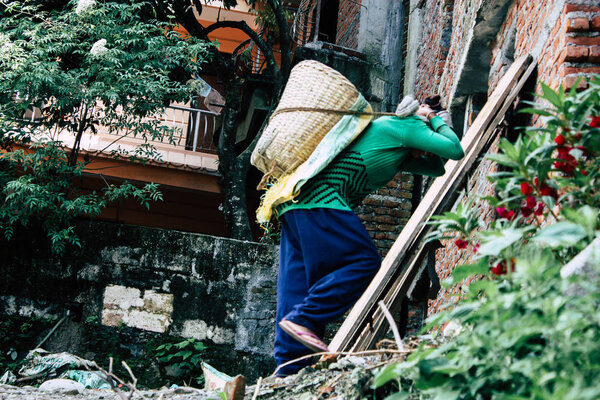 Pokhara Nepal September 23, 2018 Closeup of Nepalese porter carrying sand for construction of a new house in Pokara Lakeside in the afternoon
