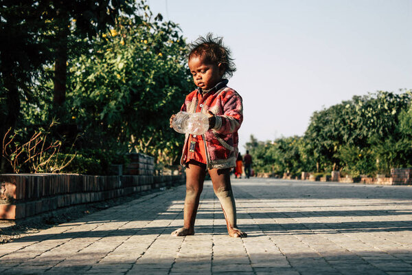 Lumbini Nepal November 2, 2018 Portrait of young unknown Nepalese beggar child living in Buddha Gardens at Lumbini in the afternoon