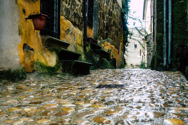 Calcata Italy September 22, 2019 View of the street of the medieval village of Calcata from the floor and under the rain in the afternoon