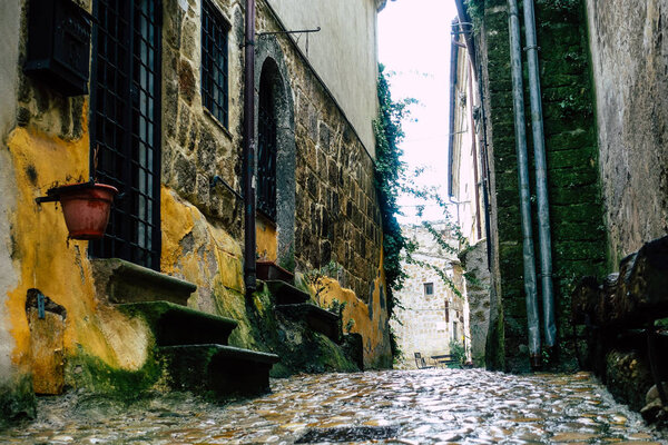 Calcata Italy September 22, 2019 View of the street of the medieval village of Calcata from the floor and under the rain in the afternoon