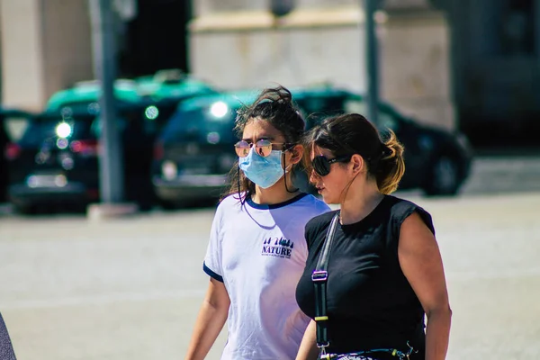 stock image Lisbon Portugal August 01, 2020 View of unidentified pedestrians with a face mask to protect themself from the coronavirus walking in the historical streets of Lisbon, the capital city of Portugal