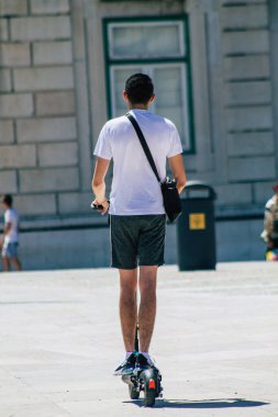 Lizbon 4 Ağustos 2020 'de Lizbon sokaklarında elektrikli scooterla dolaşan kimliği belirsiz insanların küçük bir iç yanmalı motorlar ve merkezde bir güverte ile çalışmalarını izledik.