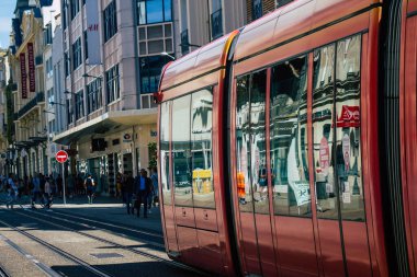 Fransa 'yı 20 Ağustos 2020' de, Fransa 'nın Grand Est bölgesindeki bir şehir olan Reims toplu taşıma sisteminin bir parçası olan caddelerden geçen yolcular için modern bir elektrikli tramvaya bakıyor.
