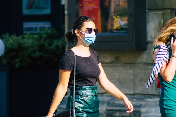 Fransa 'yı 12 Eylül 2020' de, Fransa 'nın Grand Est bölgesindeki bir şehir olan Reims sokaklarında yürüyen koronavirüsten kendilerini korumak için maske takan kimliği belirsiz yayalara bakıyor.