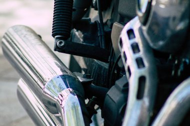 Şehir merkezinin caddelerinde yuvarlanan bir motorsikletin yakın çekimi.