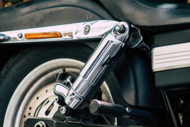 Şehir merkezinin caddelerinde yuvarlanan bir motorsikletin yakın çekimi.