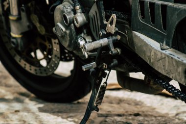 Şehir merkezinin caddelerinde yuvarlanan bir motorsikletin yakın çekimi.