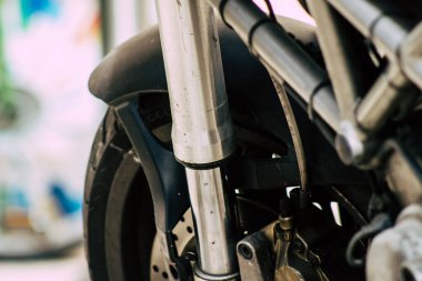 Şehir merkezinin caddelerinde yuvarlanan bir motorsikletin yakın çekimi.