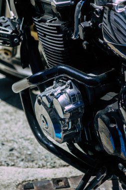 Şehir merkezinin caddelerinde yuvarlanan bir motorsikletin yakın çekimi.