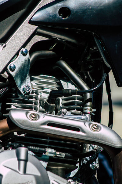 Closeup of a motorcycle rolling in the streets of the city center of the metropolitan area