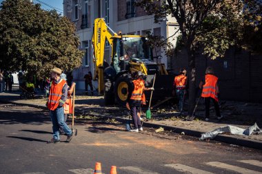 Kharkiv, Ukrayna, 16 Eylül 2025 Temizlik işçileri, Rus Şahin İHA 'sının bir binaya çarptığı sokakta karşılık veriyor. Hasar büyüktü ve bina alev aldı..