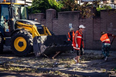 Kharkiv, Ukrayna, 16 Eylül 2025 Temizlik işçileri, Rus Şahin İHA 'sının bir binaya çarptığı sokakta karşılık veriyor. Hasar büyüktü ve bina alev aldı..