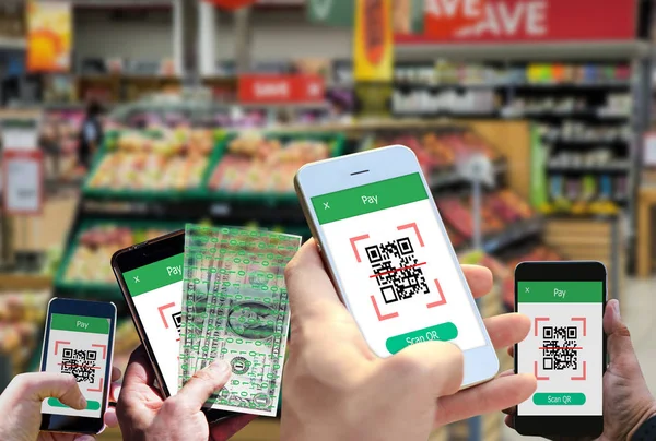 Hand holding smartphone to scan QR code payment , online shopping , cashless technology concept.