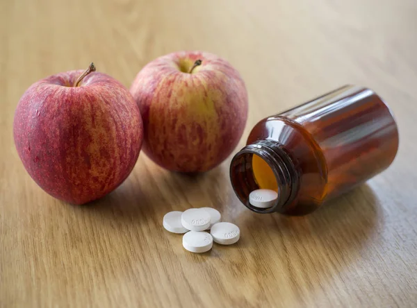 Vitamin C pills and Apple