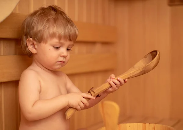 Beauty, healthcare. baby Boy relaxing in the sauna Toddler with broom and hat in russian sauna or bath — Stock Photo, Image