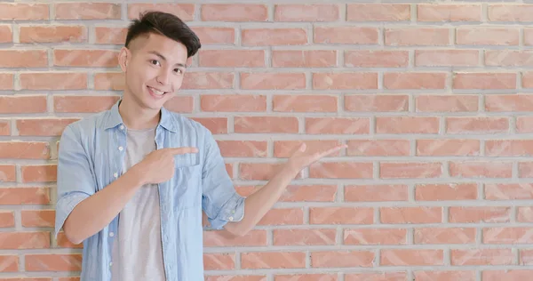 Man Showing Something Bricks Wall Background — Stock Photo, Image