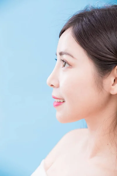 beauty woman profile, woman  looking  somewhere on the blue background