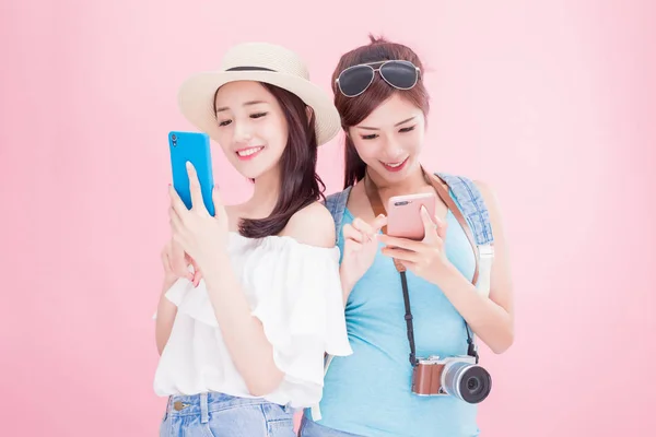 Zwei Reisefrauen Mit Smartphones Auf Rosa Hintergrund — Stockfoto