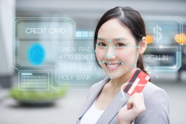 Asian young  businesswoman using face recognition login credit card clipart