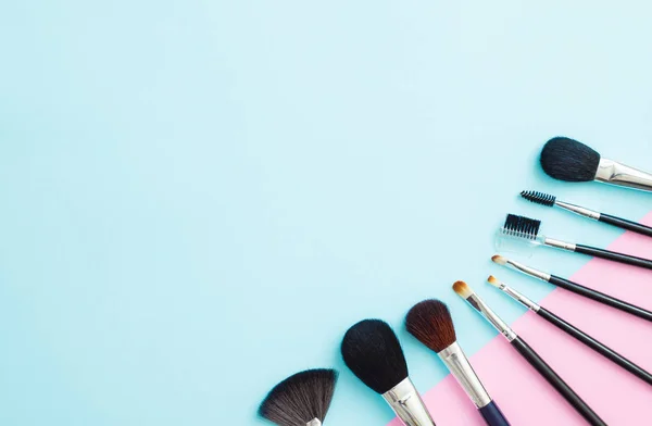 Makeup cosmetic products on blue and pink background