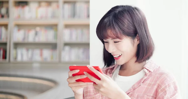 Молодая женщина играет в мобильные игры — стоковое фото