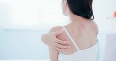 woman scratching shoulder and neck clipart
