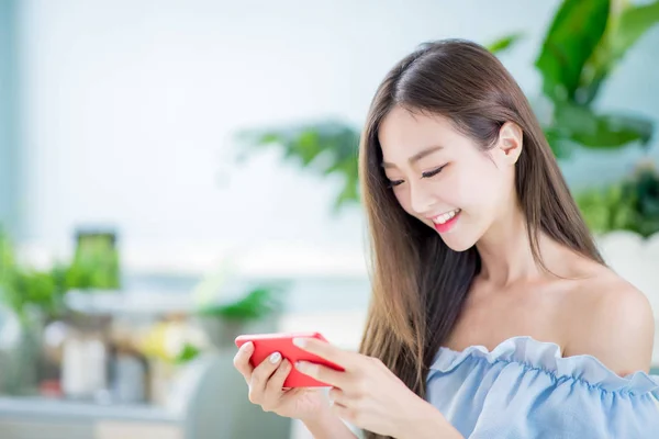 young woman play mobile game