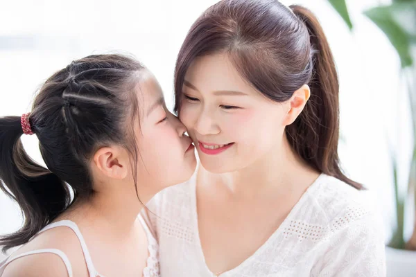 Daughter kiss mom tenderly