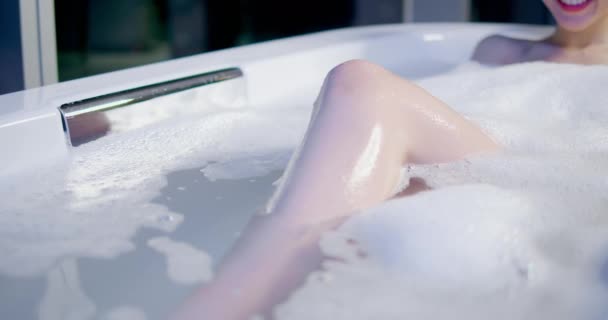 Молодая женщина принимает ванну — стоковое видео