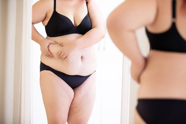 Plus size girl look mirror — Stock Photo, Image