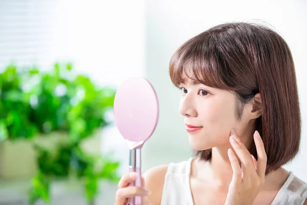 Young asian woman look mirror — Stock Photo, Image