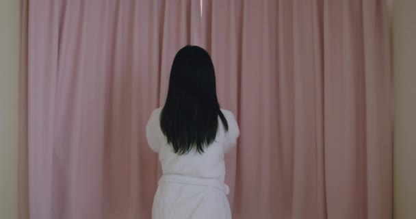 Slow motion woman opening curtain — Stock Video