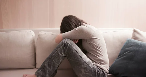 Kvinna känner sig deprimerad på soffan — Stockfoto