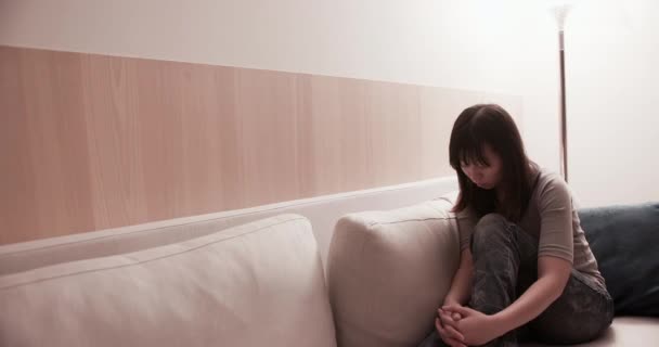 Mujer se siente deprimida en el sofá — Vídeo de stock