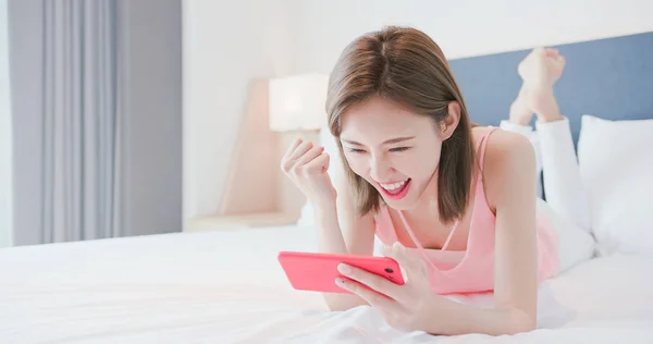 woman play mobile game happily