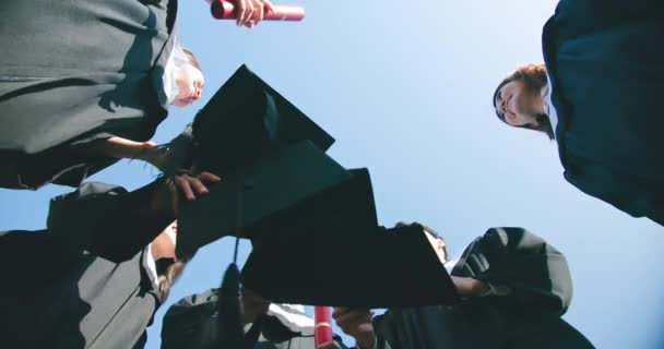 Group happy graduates throw caps — Stock Video