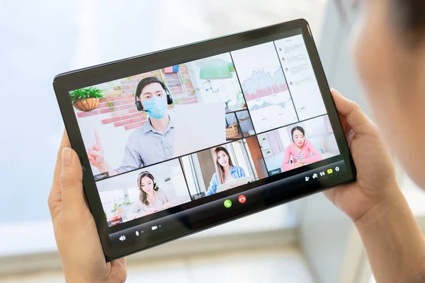 businesspeople have online video meeting on tablet with colleague who are isolated at home