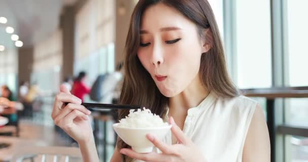 Vrouw eet rijst in restaurant — Stockvideo