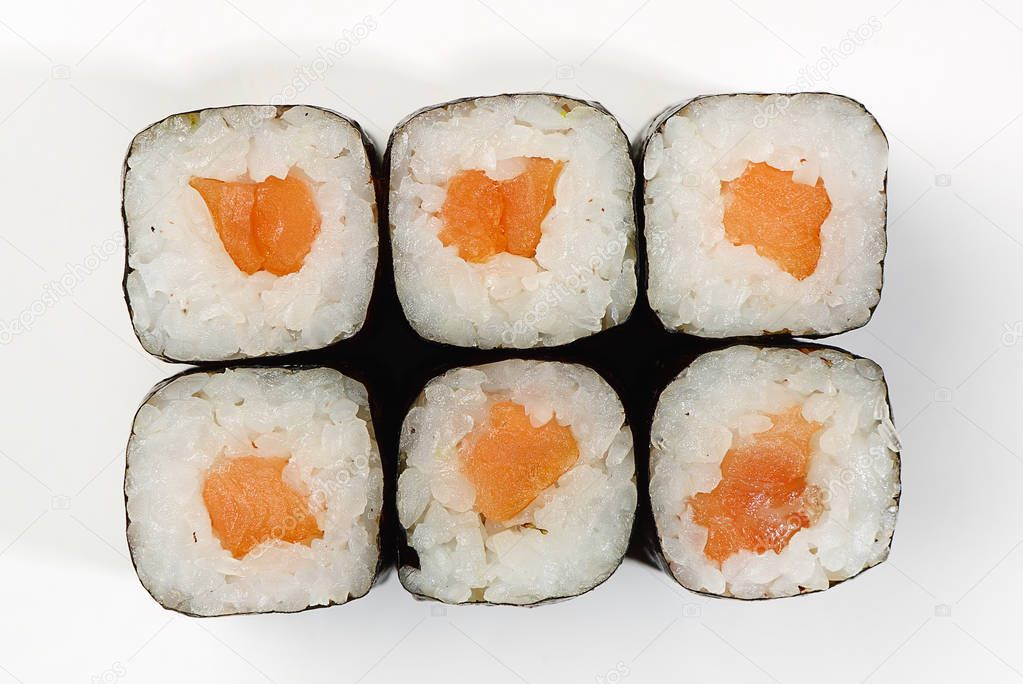 Rolls of Hosomaki with smoked salmon, top view, white background.