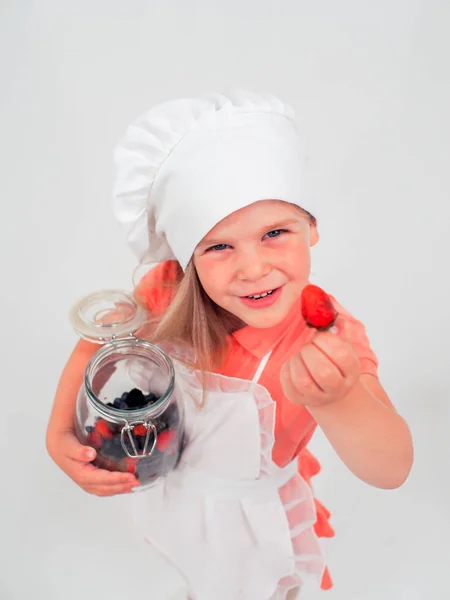 cute little girl holding a jar of berries