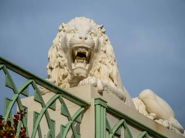 ancient sculpture of a roaring lion in the historical Park